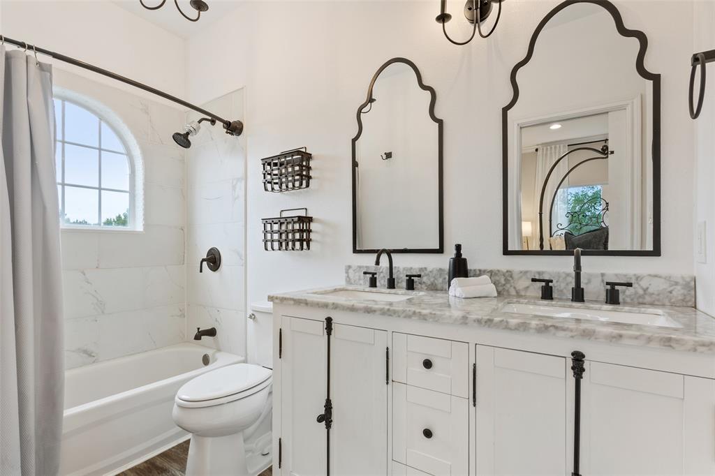 566 Benevolence Way China Spring, TX 76633 - Photo 22 of 35 a bathroom with a double vanity sink and mirror with bathtub