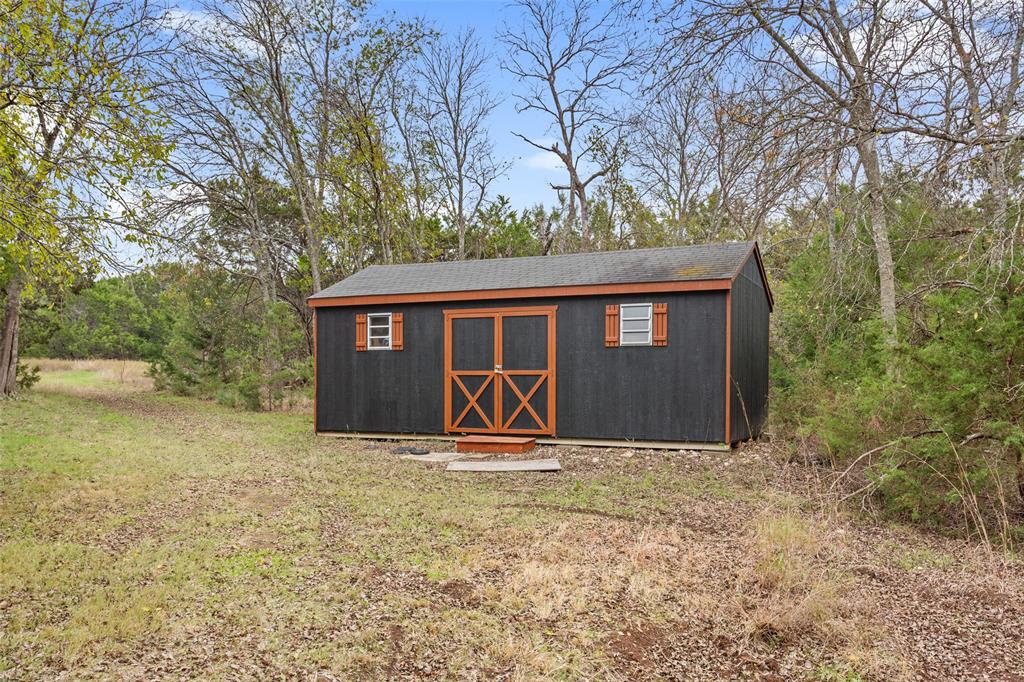 566 Benevolence Way China Spring, TX 76633 - Photo 34 of 35 a front view of a house with garden