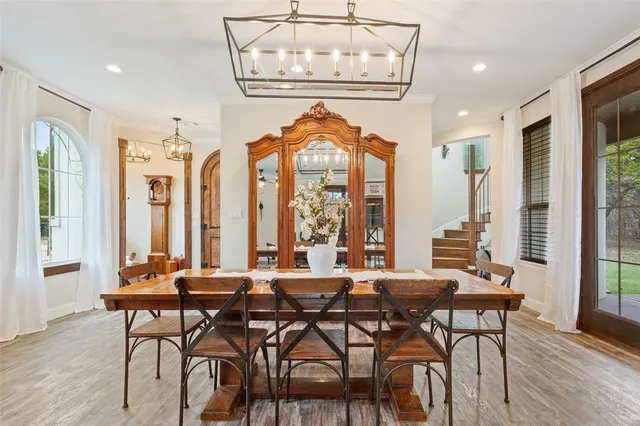 a view of a a dining room with furniture window and wooden floor