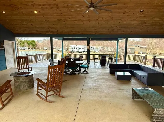 a living room with furniture and a floor to ceiling window