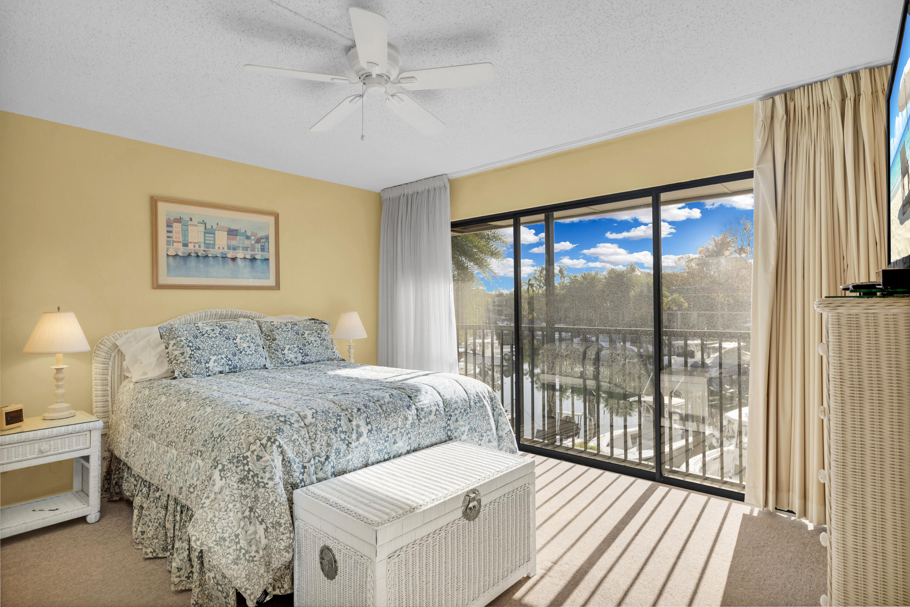 96000 Overseas Highway, Unit E5 Key Largo, FL 33037 - Photo 17 of 47 a bedroom with a large bed and a large window with outer view