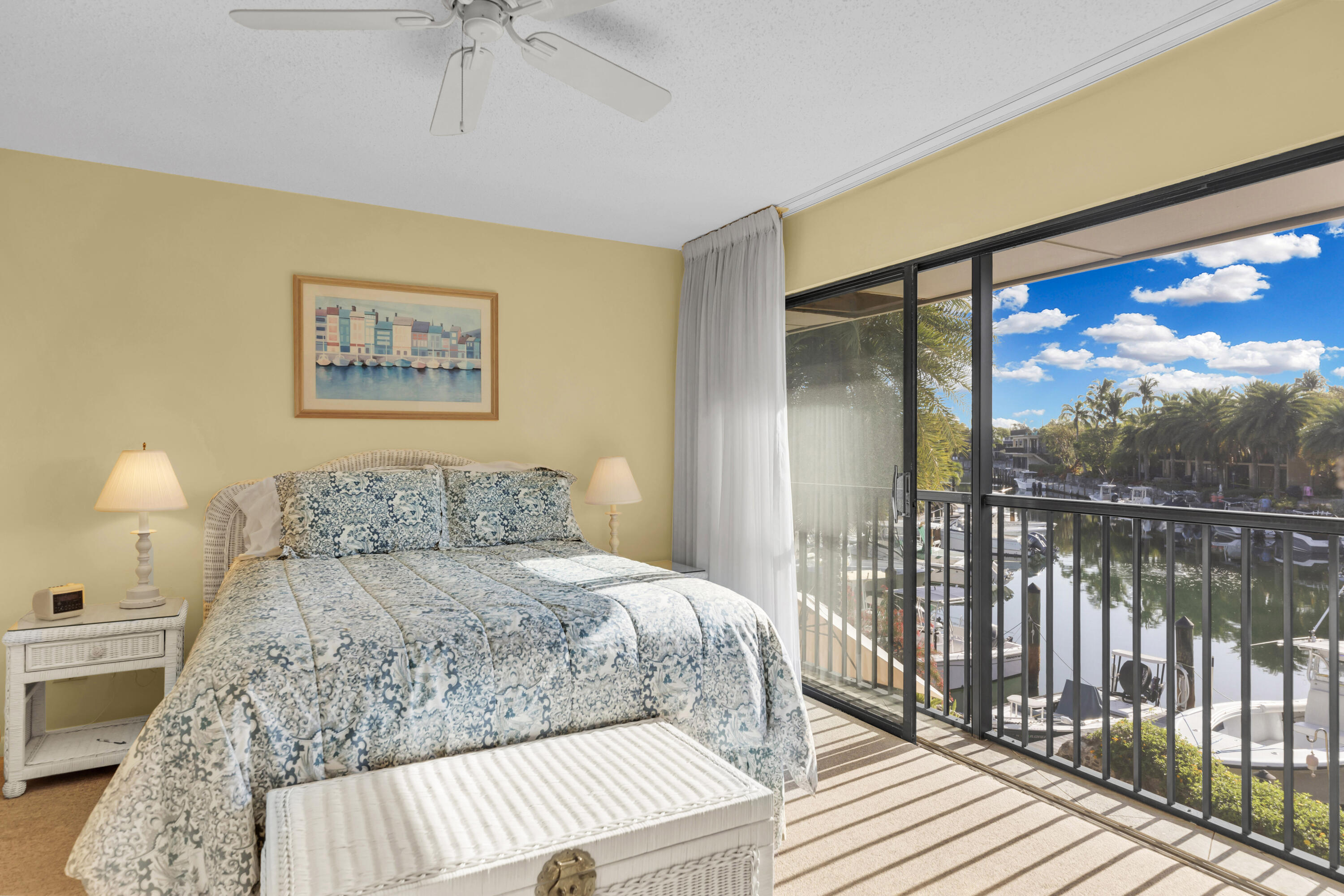 96000 Overseas Highway, Unit E5 Key Largo, FL 33037 - Photo 18 of 47 a bedroom with a bed and a painting on the wall