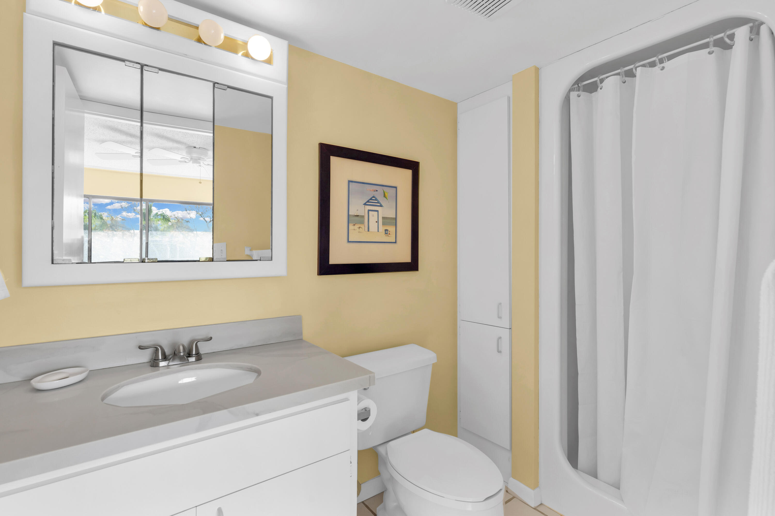 96000 Overseas Highway, Unit E5 Key Largo, FL 33037 - Photo 21 of 47 a bathroom with a granite countertop sink toilet and a mirror