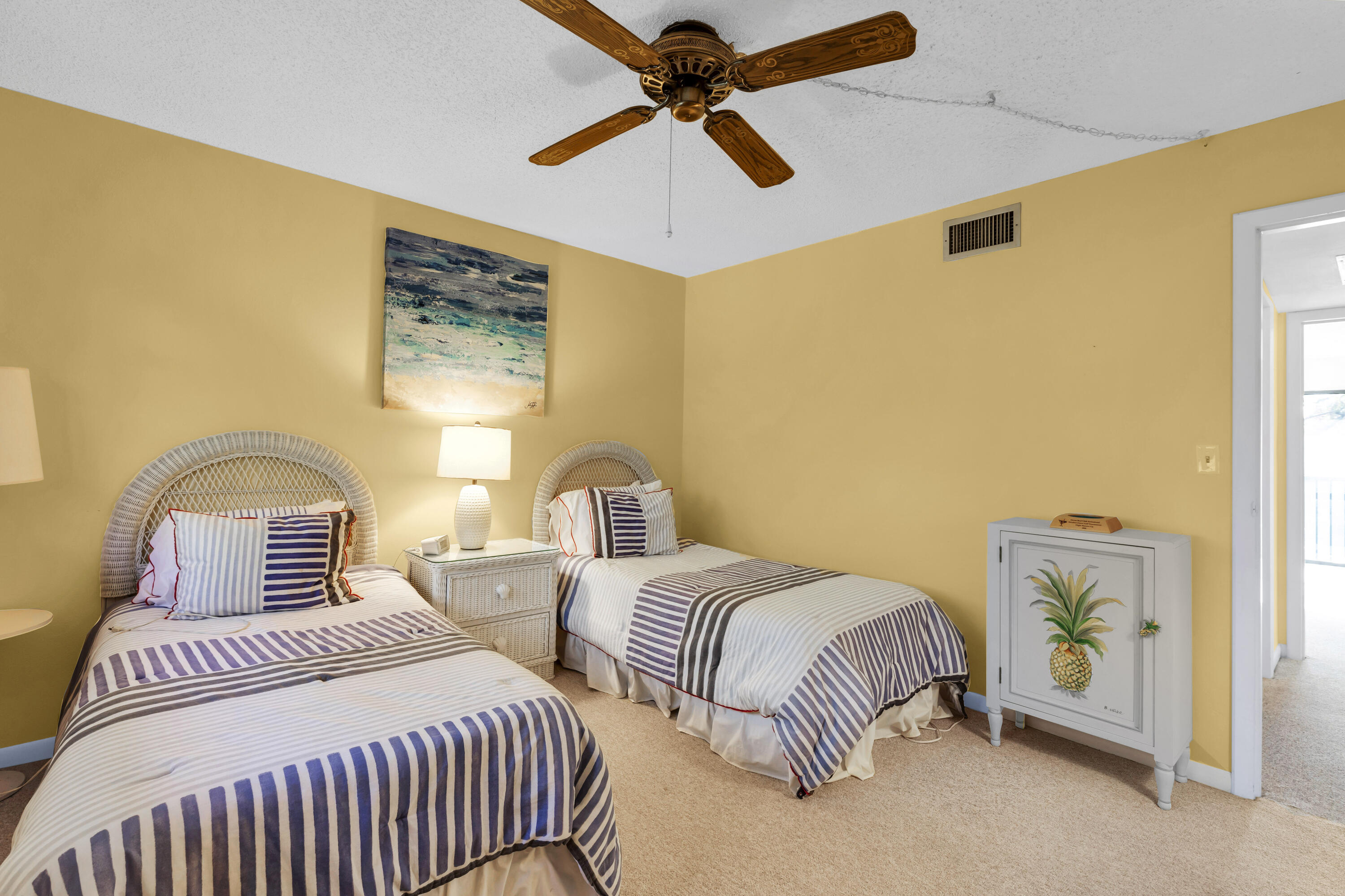 96000 Overseas Highway, Unit E5 Key Largo, FL 33037 - Photo 23 of 47 a bedroom with two beds and painting on the wall