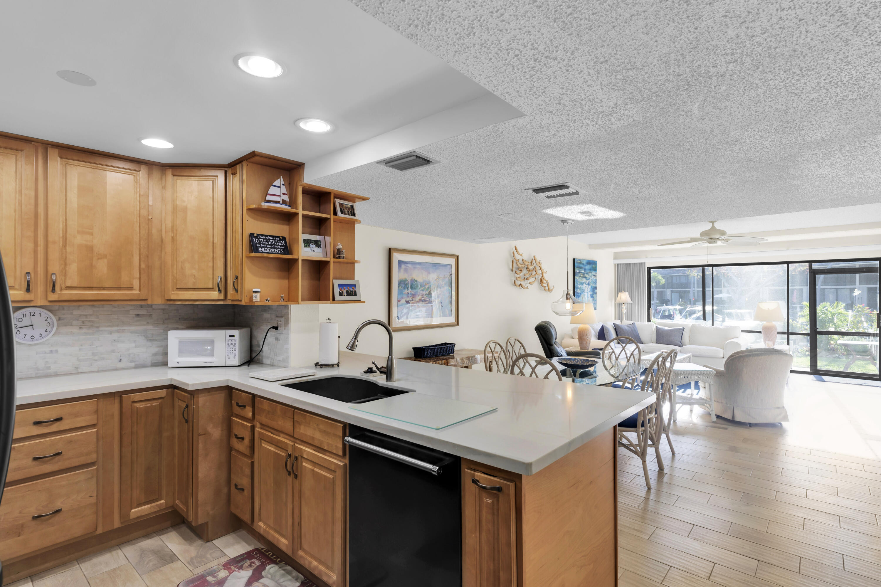 96000 Overseas Highway, Unit E5 Key Largo, FL 33037 - Photo 3 of 47 a kitchen with sink refrigerator and cabinets