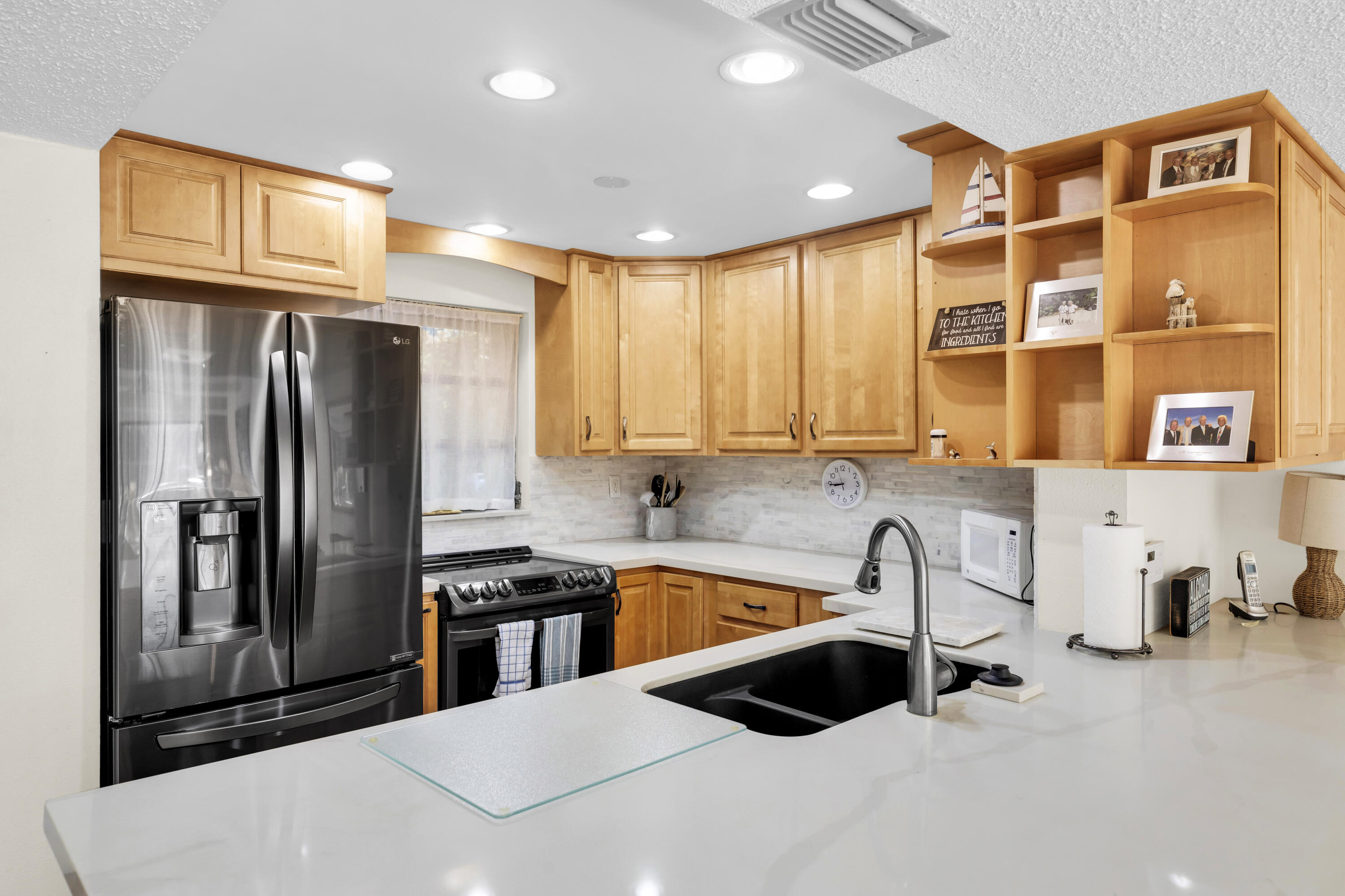 96000 Overseas Highway, Unit E5 Key Largo, FL 33037 - Photo 5 of 47 a kitchen with stainless steel appliances a sink and a refrigerator