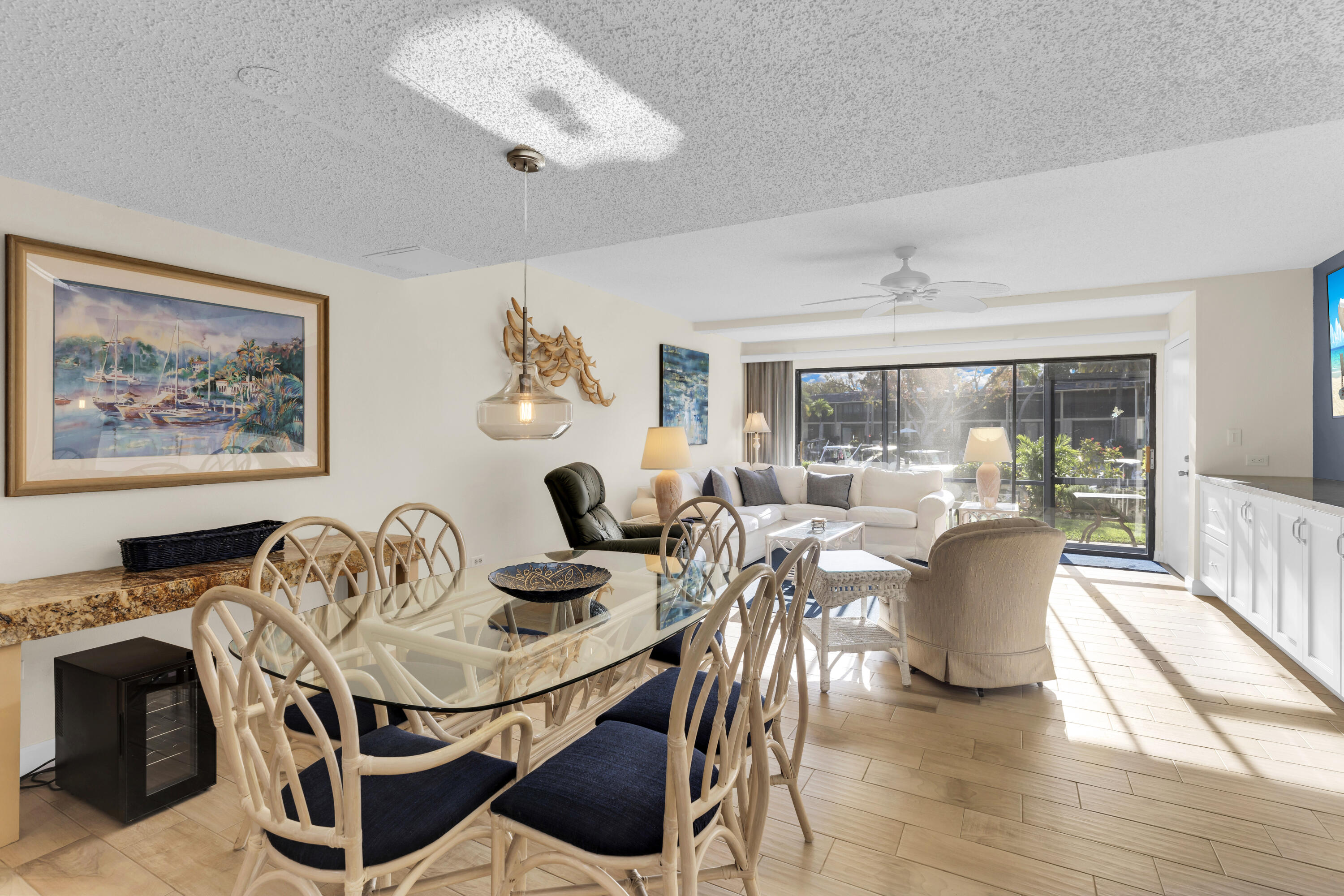 96000 Overseas Highway, Unit E5 Key Largo, FL 33037 - Photo 6 of 47 a dining room with furniture a window and wooden floor