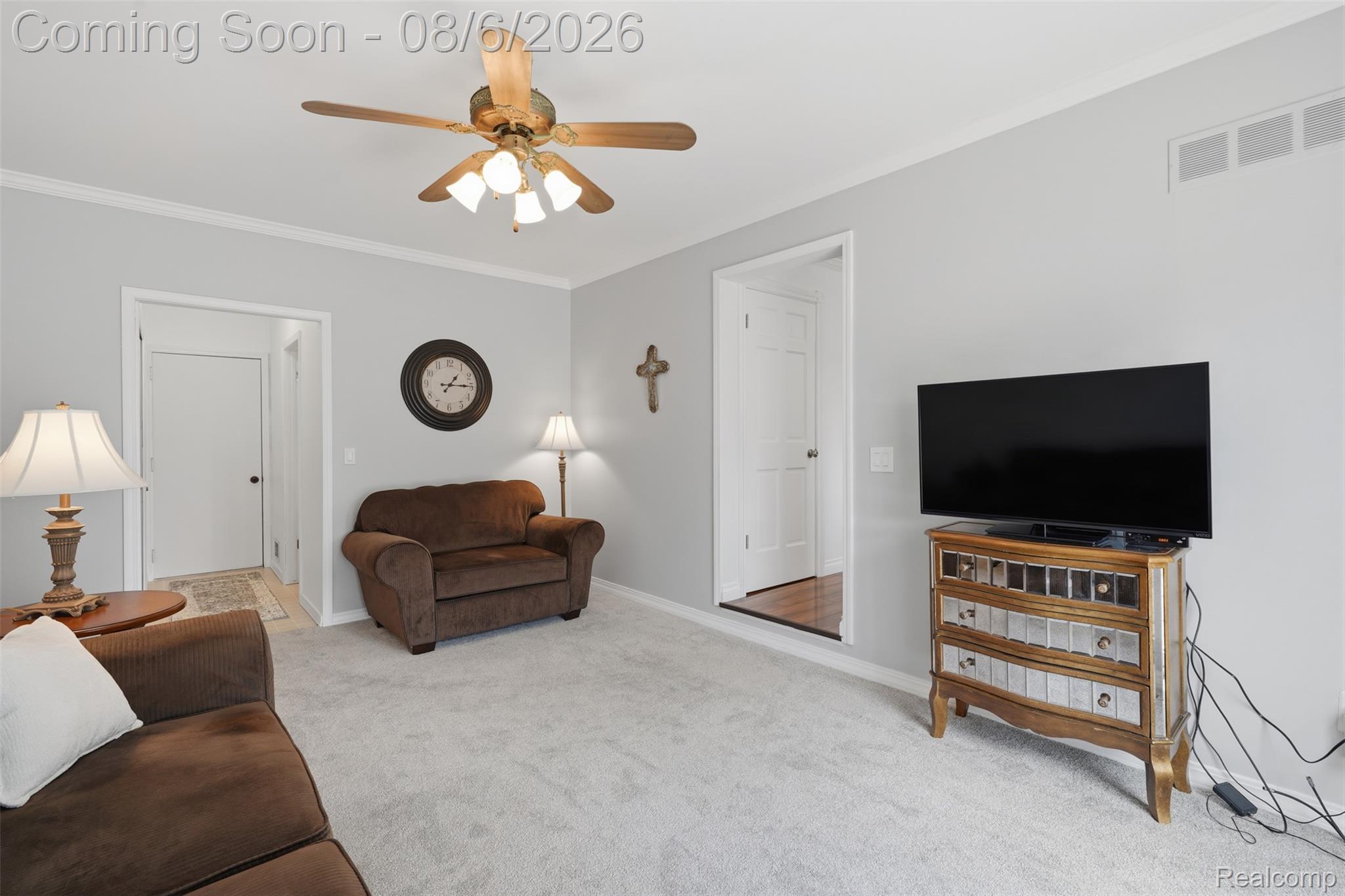 3585 Loon Lake Road Wixom, MI 48393 - Photo 11 of 40 Carpeted living area featuring light gray walls, white trim, and a ceiling fan with integrated lighting