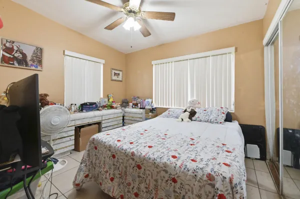 a bed room with a bed and a chandelier