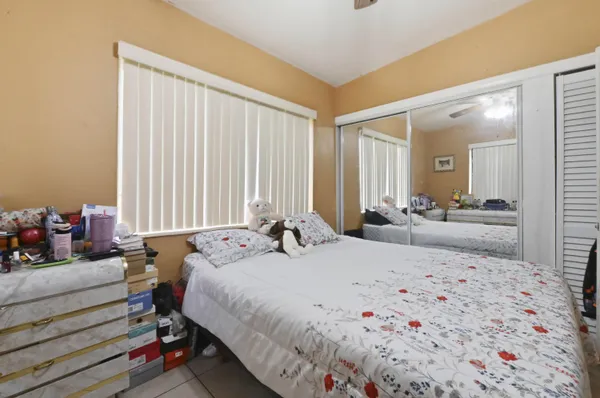 a bedroom with bed and a mirror