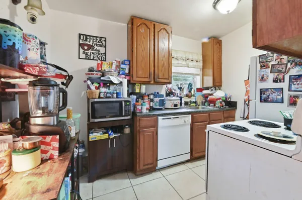 a kitchen filled with a stove top oven and cabinets