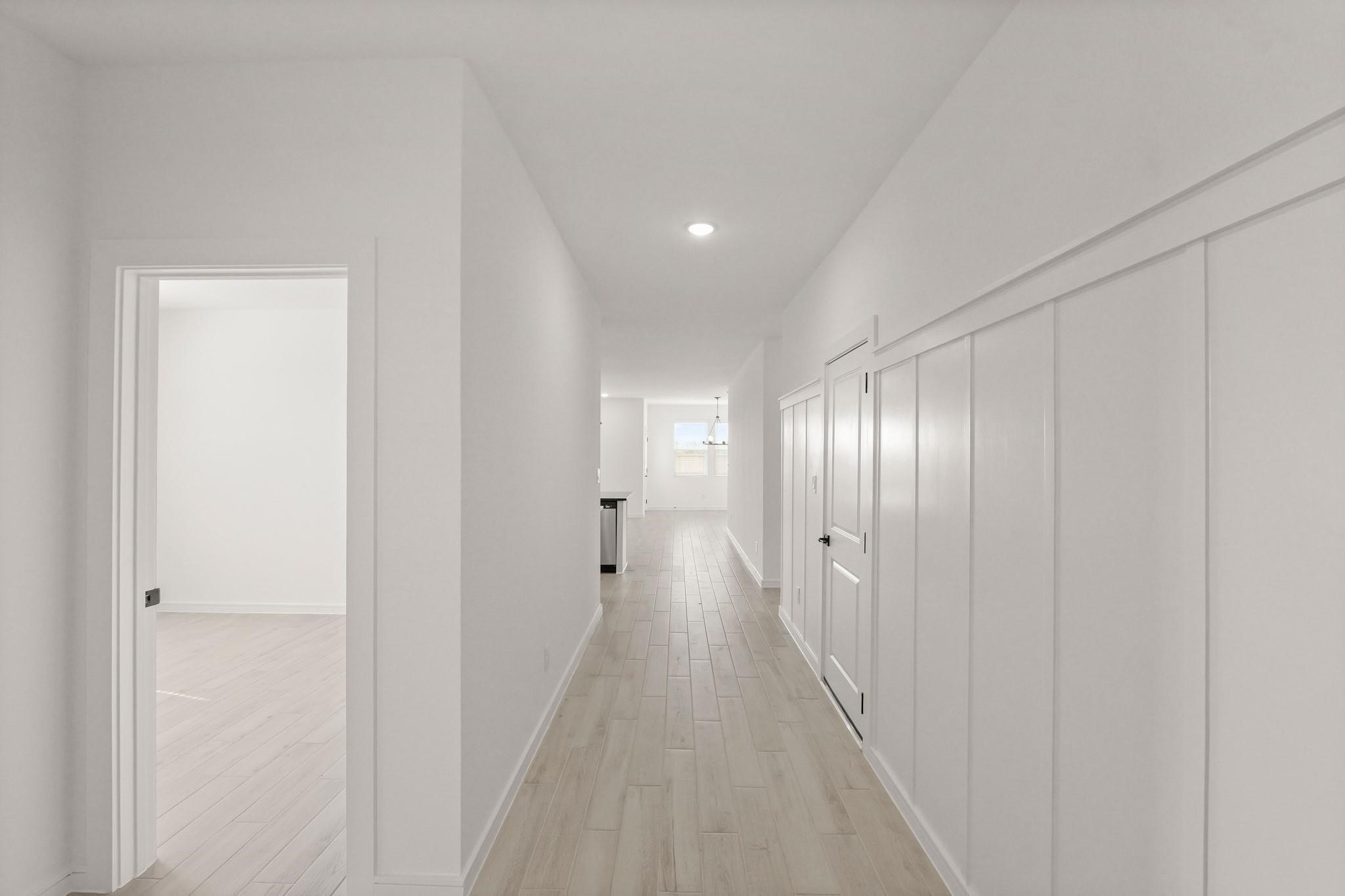 7815 Jade Crest Drive Angleton, TX 77515 - Photo 4 of 31 a view of a hallway with wooden floor