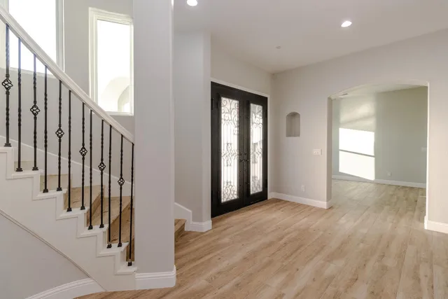 a view of an entryway with wooden floor