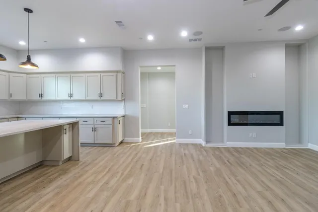 a view of a kitchen with a sink and a refrigerator