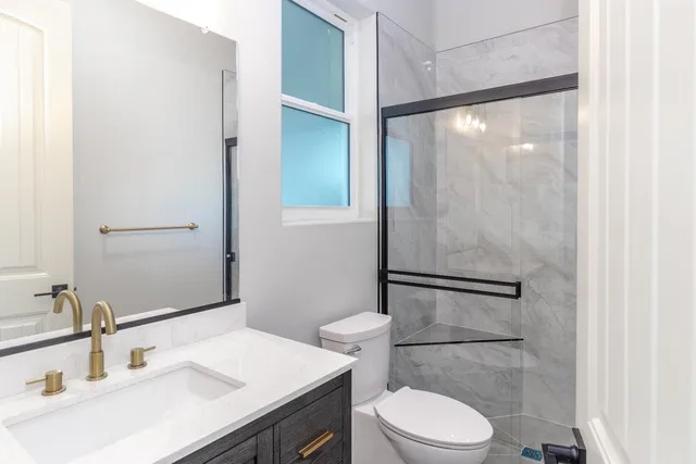 a bathroom with a sink toilet and shower