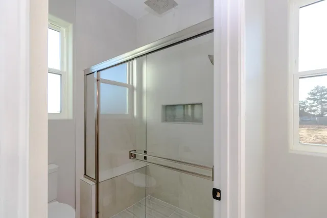 a bathroom with a glass shower door