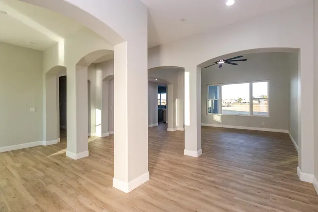 a view of a hallway with wooden floor and glass door