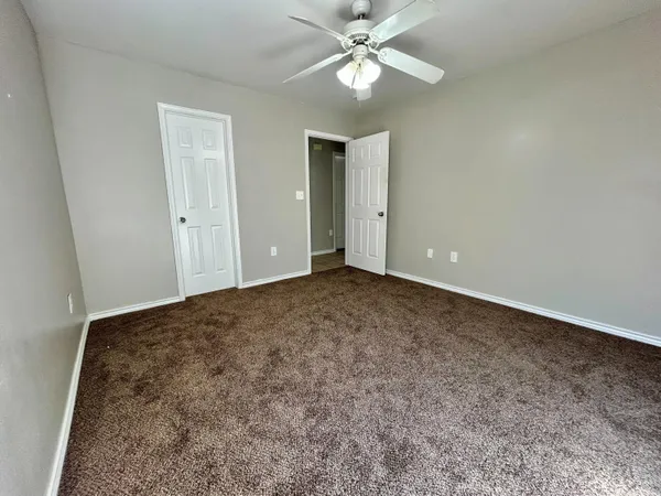 an empty room with fan and fan