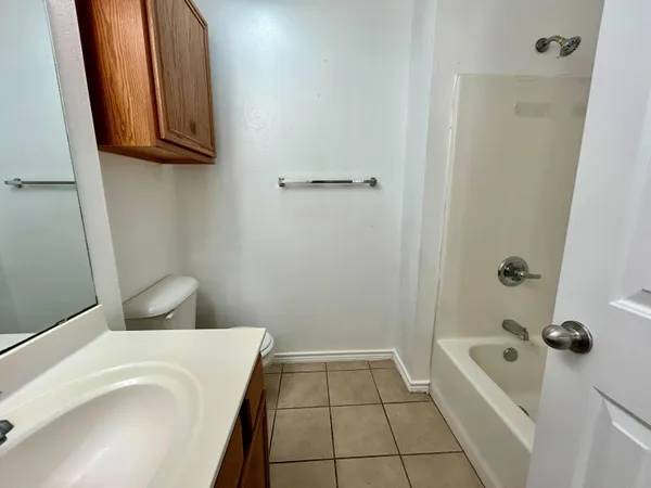 a bathroom with a tub a toilet and a sink