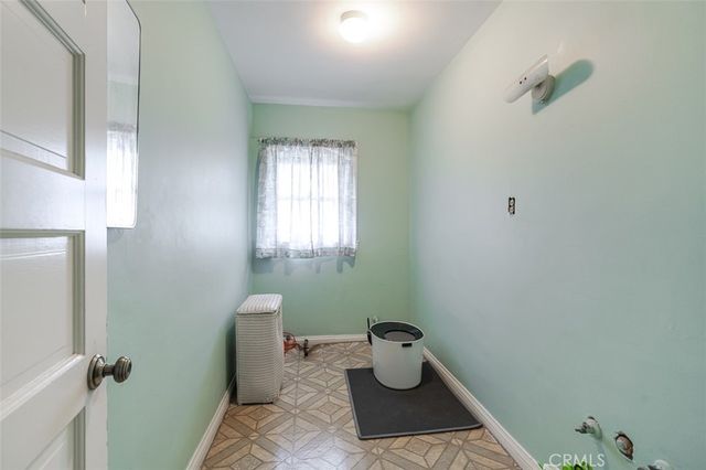 a bathroom with a toilet and a window