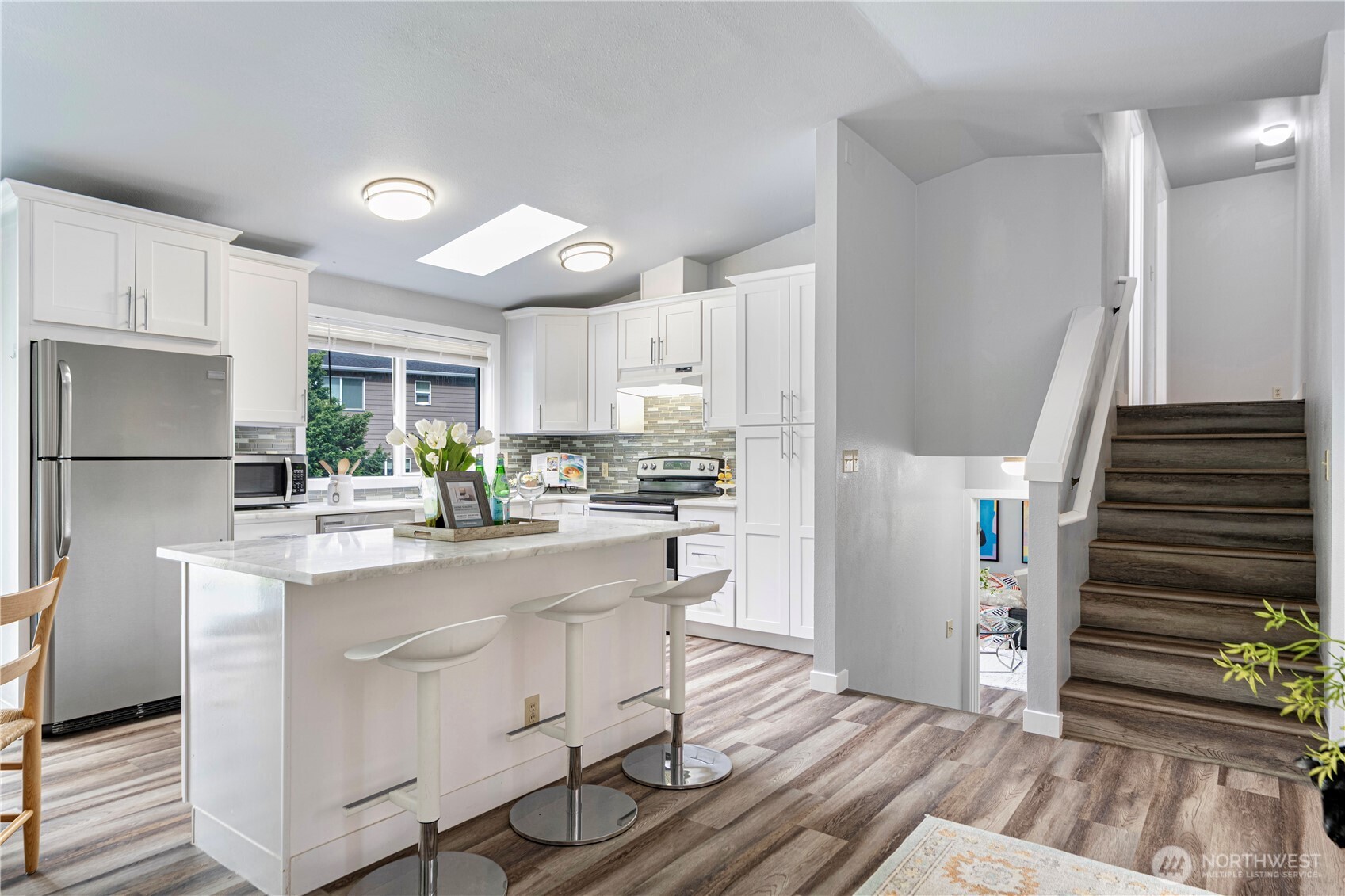 2 199th Place Southeast Bothell, WA 98012 - Photo 4 of 30 a kitchen with white cabinets and stainless steel appliances