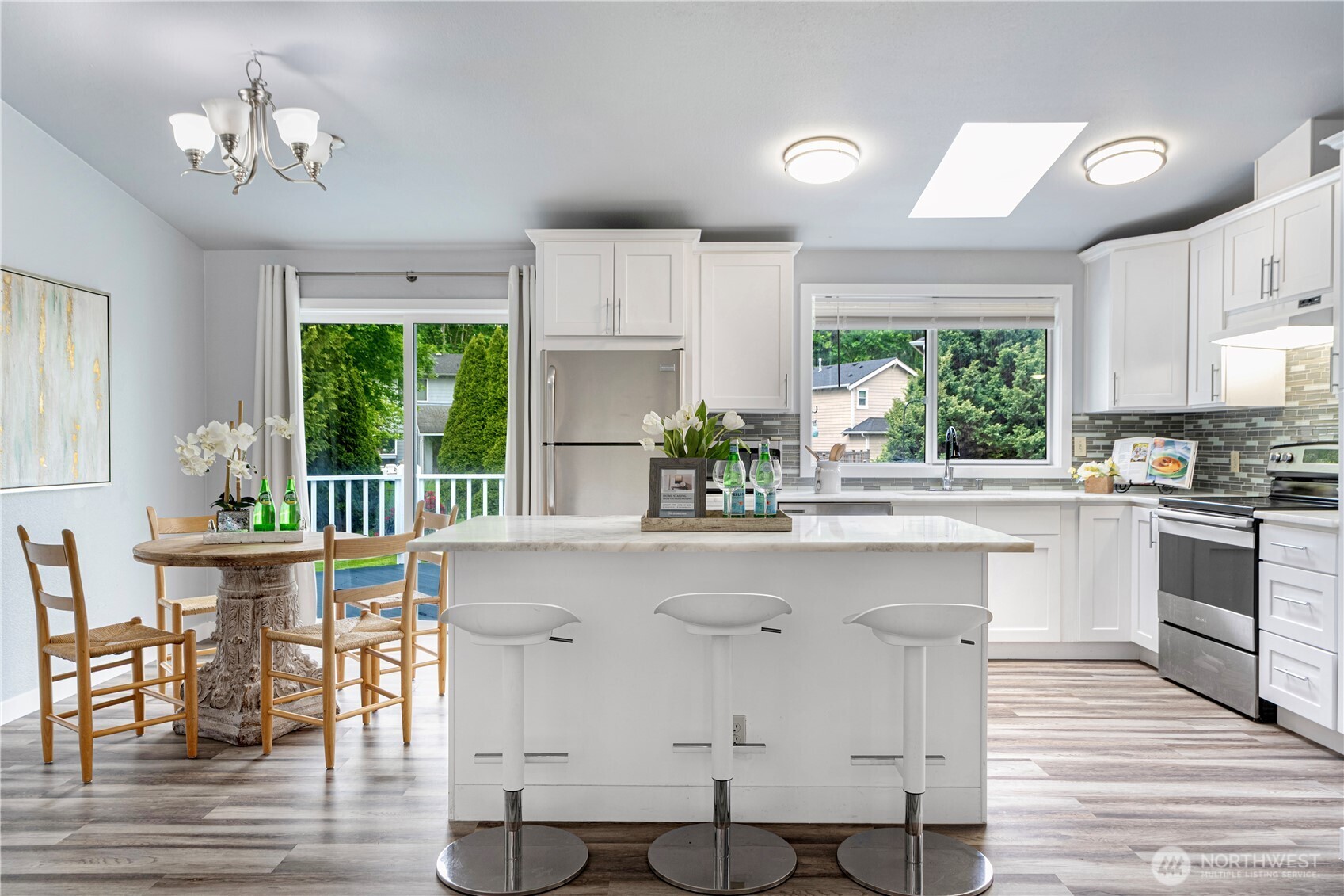 2 199th Place Southeast Bothell, WA 98012 - Photo 5 of 30 a kitchen with a table chairs stove and cabinets