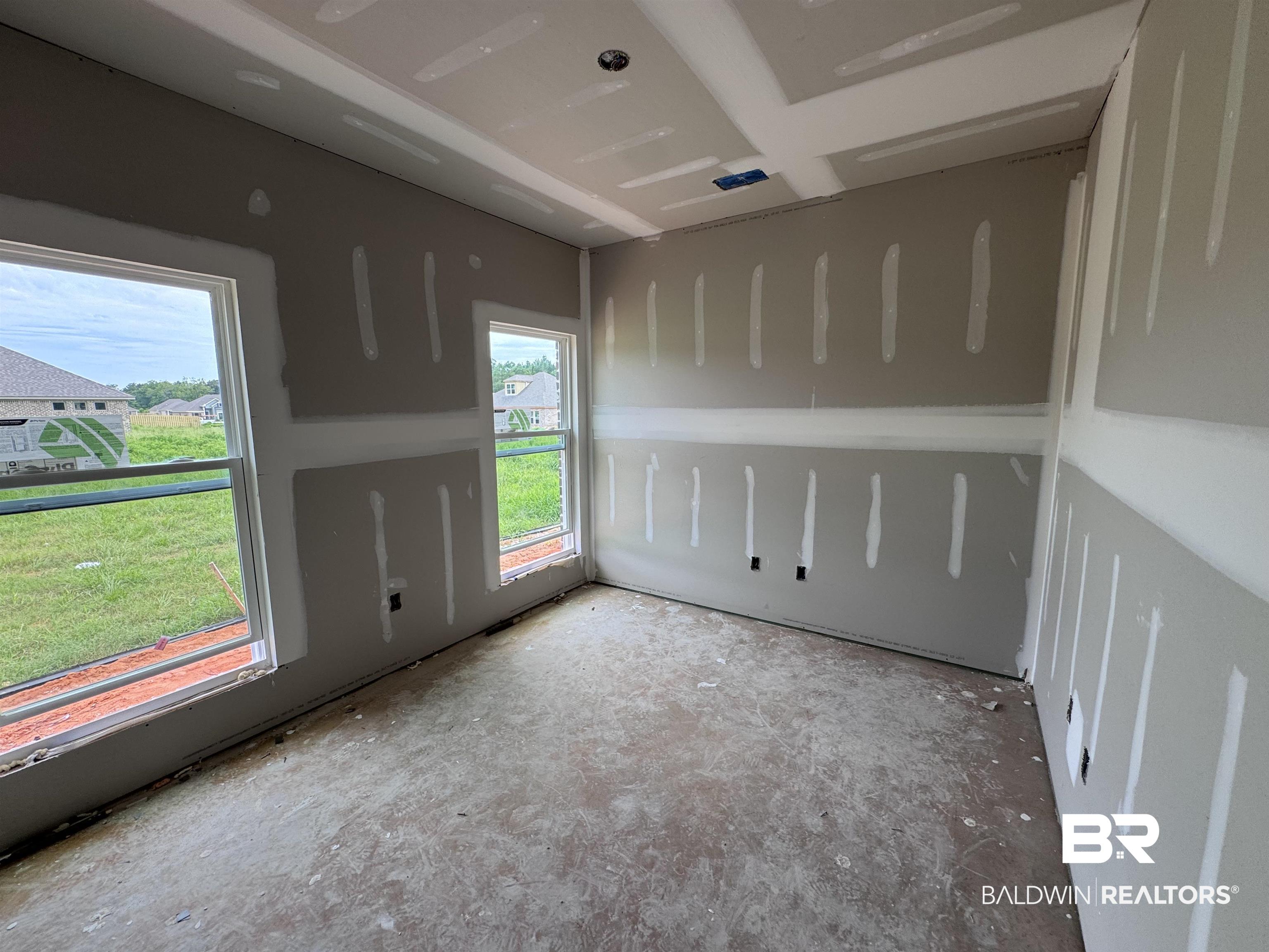27355 Patch Pl Loop Daphne, AL 36526 - Photo 9 of 17 Room under construction featuring drywall installation, two large windows, two smaller windows