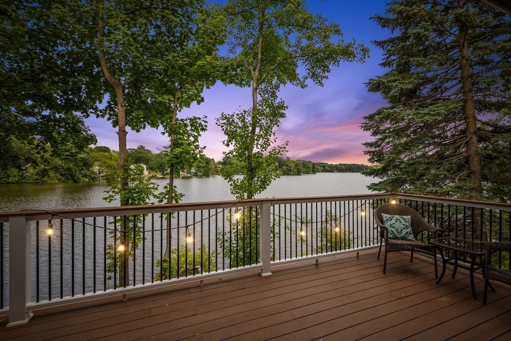 a view of balcony with wooden floor and outdoor seating