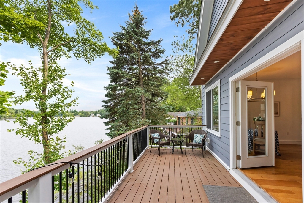 46 Crescent Avenue Lynnfield, MA 01940 - Photo 11 of 16 a view of roof deck with table and chairs and wooden floor