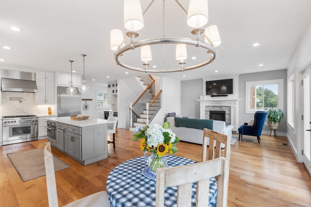 46 Crescent Avenue Lynnfield, MA 01940 - Photo 4 of 16 a living room with furniture a fireplace and a chandelier