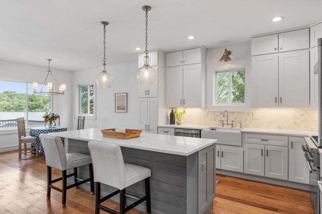 46 Crescent Avenue Lynnfield, MA 01940 - Photo 7 of 16 a kitchen with a table chairs sink and cabinets