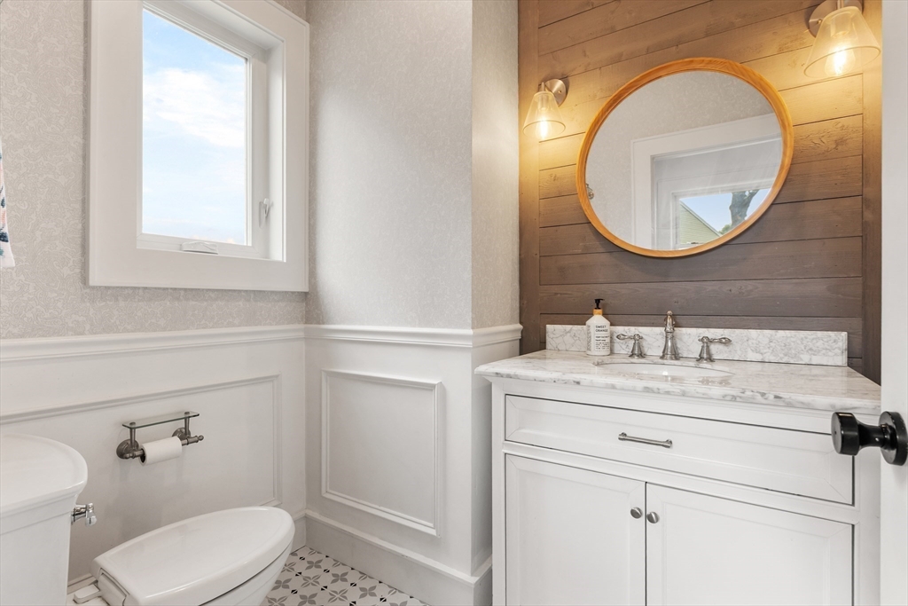 46 Crescent Avenue Lynnfield, MA 01940 - Photo 9 of 16 a bathroom with a sink a toilet and a mirror