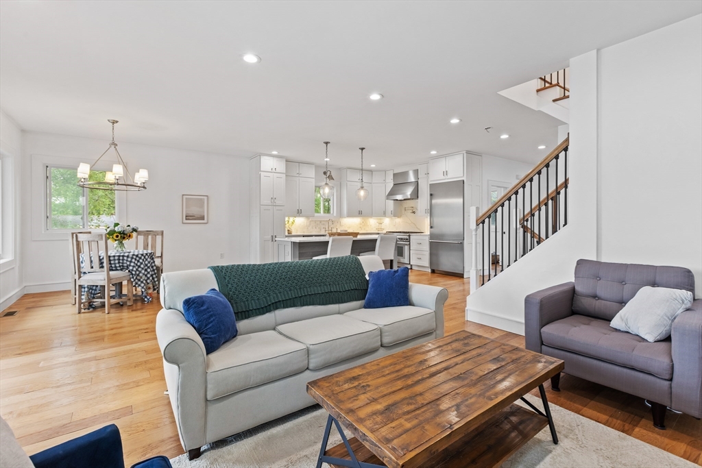 46 Crescent Avenue Lynnfield, MA 01940 - Photo 10 of 16 a living room with furniture kitchen view and a chandelier