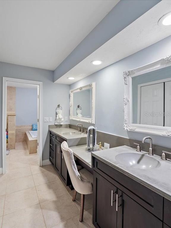 4588 Baycedar Lane Sarasota, FL 34241 - Photo 15 of 36 a bathroom with a granite countertop sink a toilet and a mirror