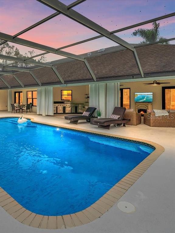 4588 Baycedar Lane Sarasota, FL 34241 - Photo 9 of 36 a view of a swimming pool with chairs