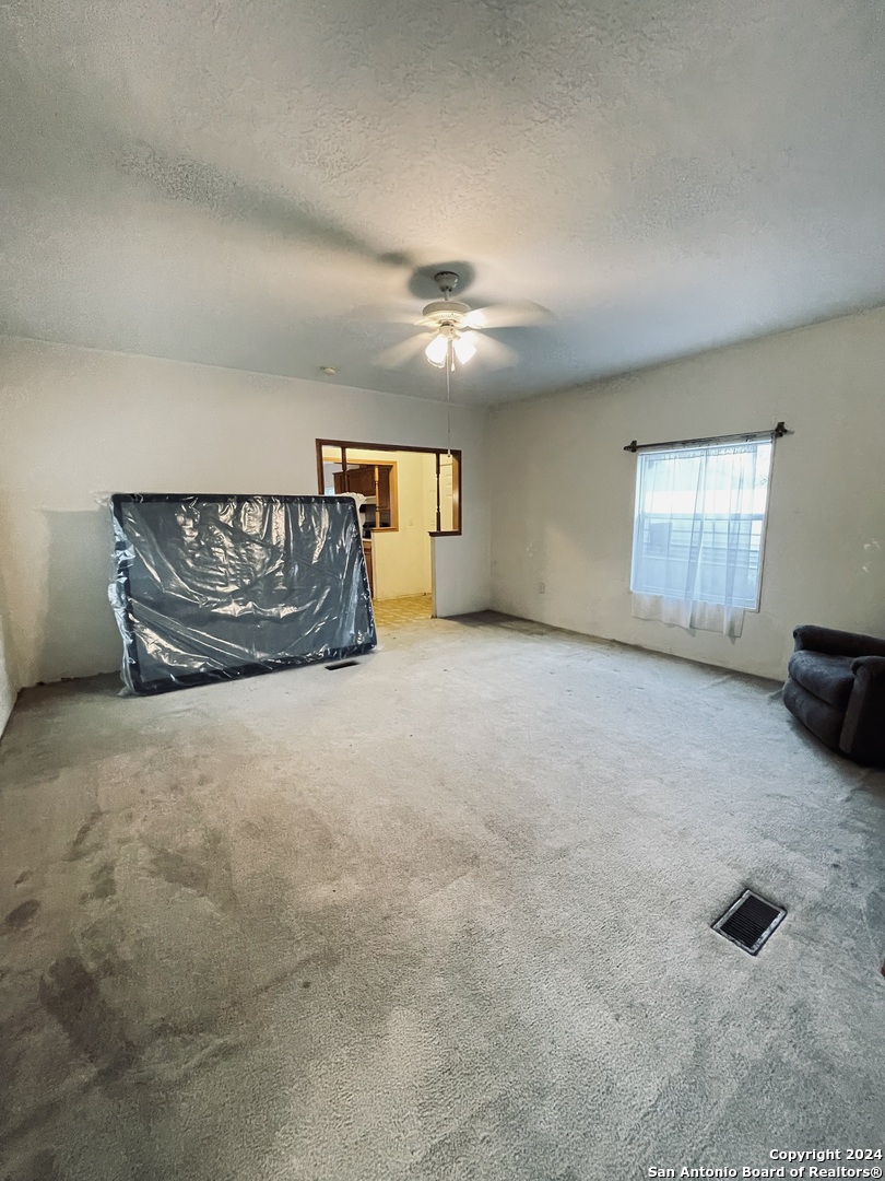 970 County Road 369 Uvalde, TX 78801 - Photo 8 of 30 an empty room with windows and fireplace
