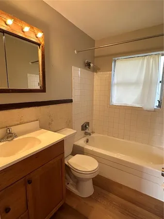 a bathroom with a toilet a sink and bathtub