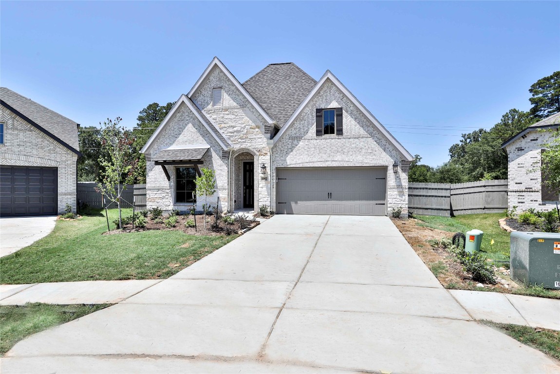 14952 Bright Berry Drive Conroe, TX 77302 - Photo 13 of 19 a front view of a house with garden