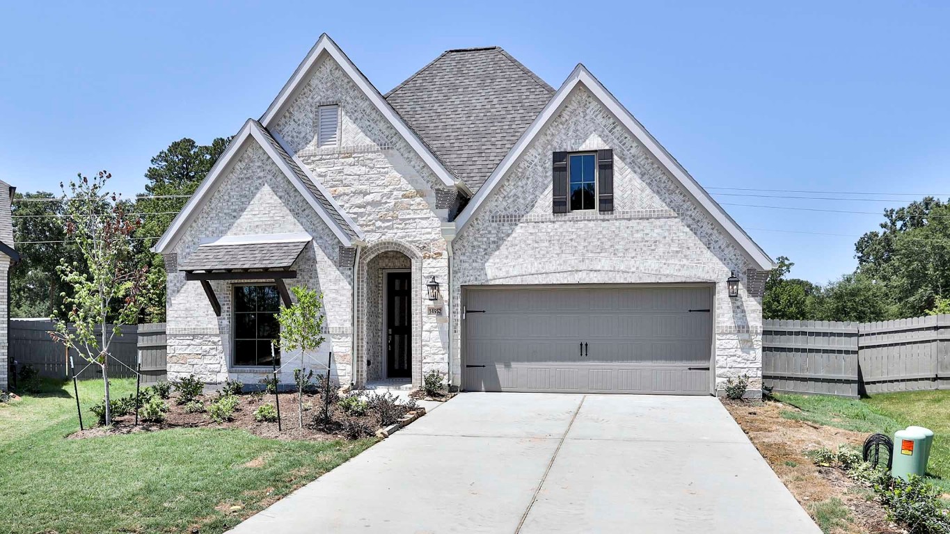14952 Bright Berry Drive Conroe, TX 77302 - Photo 14 of 19 a front view of a house with garden