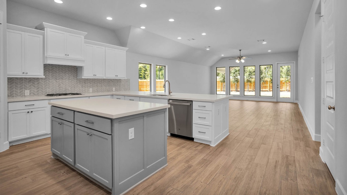 14952 Bright Berry Drive Conroe, TX 77302 - Photo 3 of 19 a kitchen with a sink stove and wooden floor