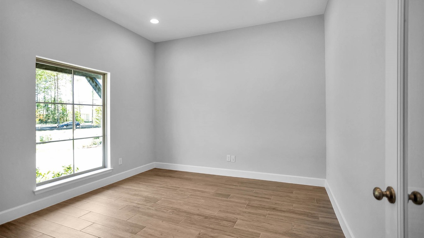 14952 Bright Berry Drive Conroe, TX 77302 - Photo 6 of 19 a view of empty room with wooden floor and fan