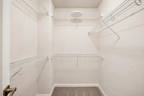 a spacious bathroom with a double vanity sink toilet and a mirror