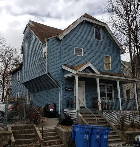 a front view of a house with barbeque area