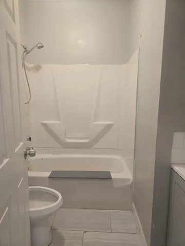 a bathroom with a shower and a toilet