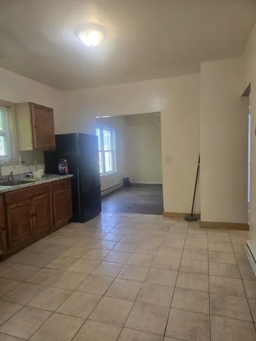 a view of a kitchen with an empty space and a window