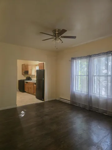a view of a kitchen with furniture and wooden floor