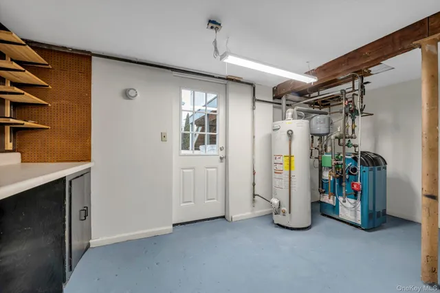 a view of storage and utility room with closet and windows