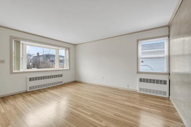 an empty room with windows and closet