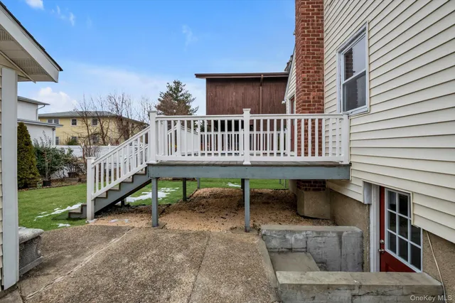 a view of a house with a yard and deck