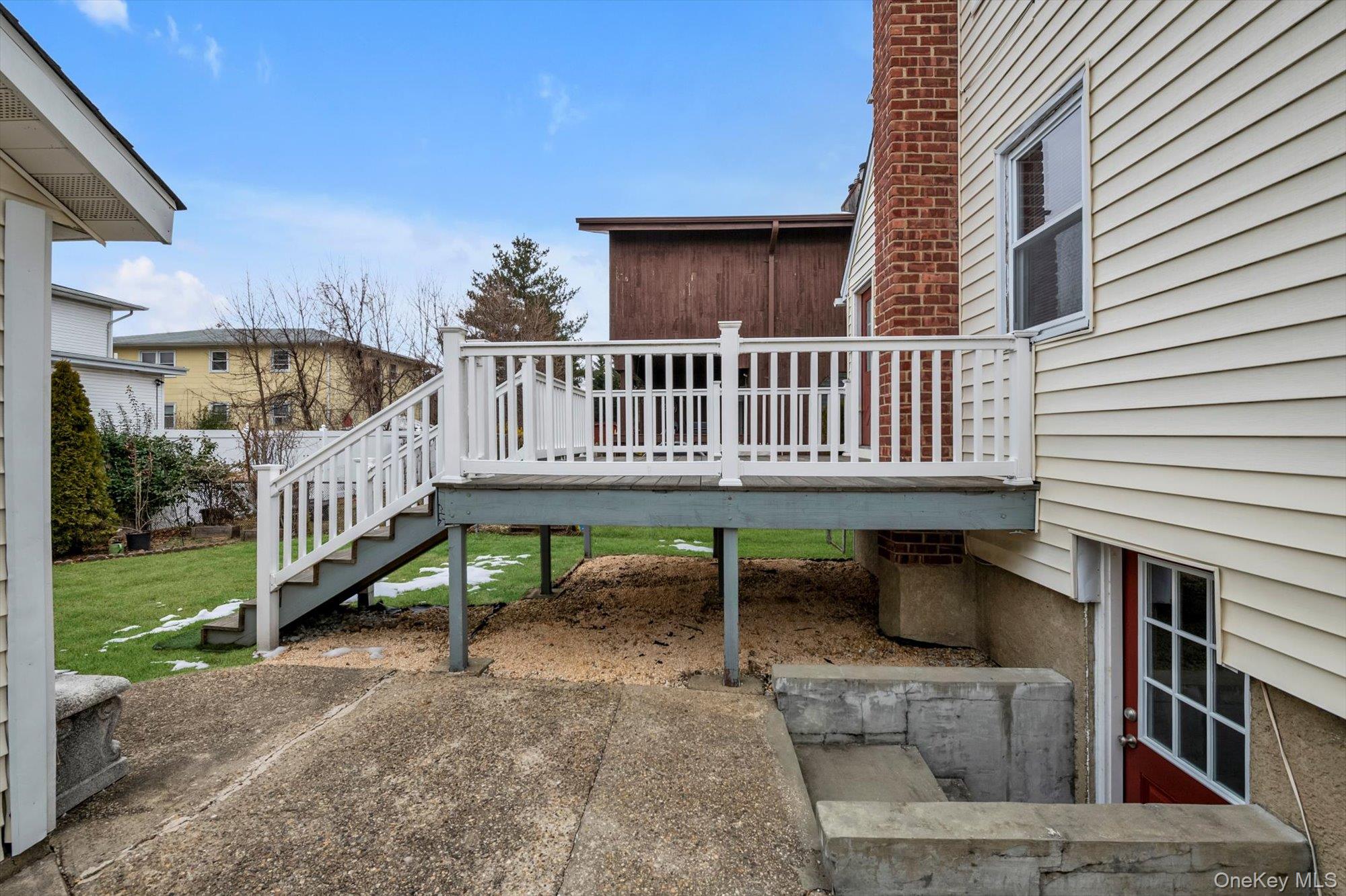9 Graywood Road Port Washington, NY 11050 - Photo 22 of 23 a view of a house with a yard and deck